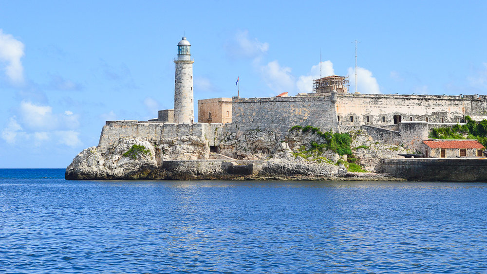 lighthouse and fort in front of the sea in Cuba