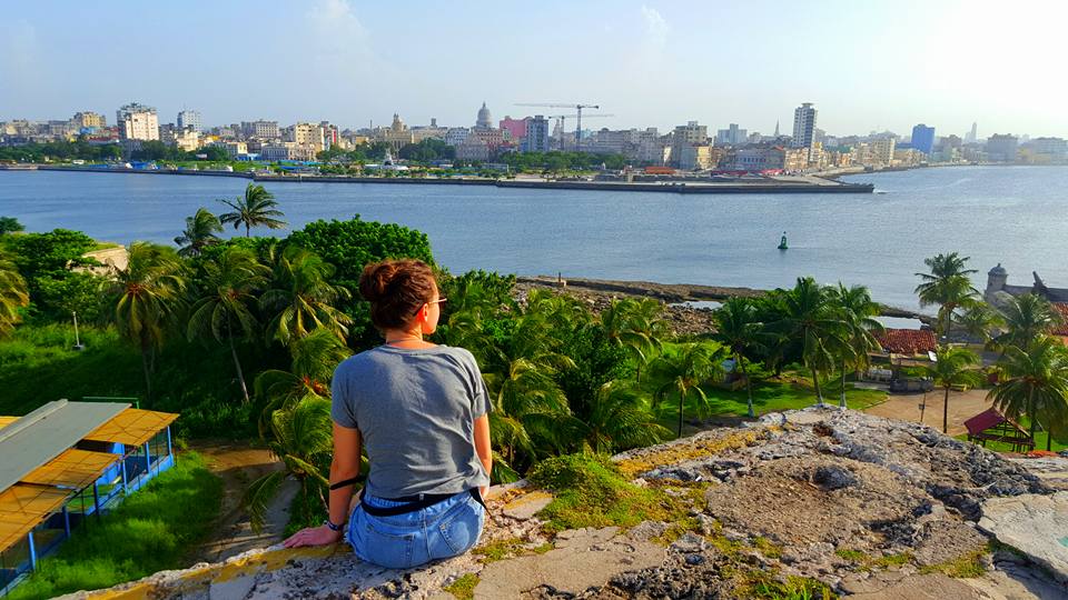 girl sat on wall looking over to Havana