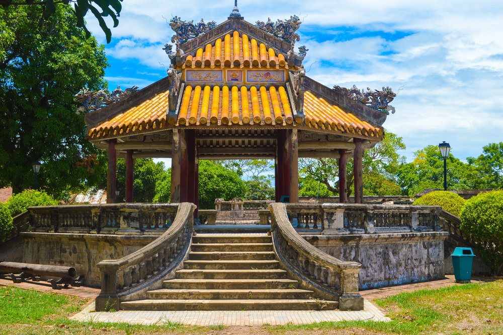 ornate pagoda with sweeping staircase and orange tiled roof
