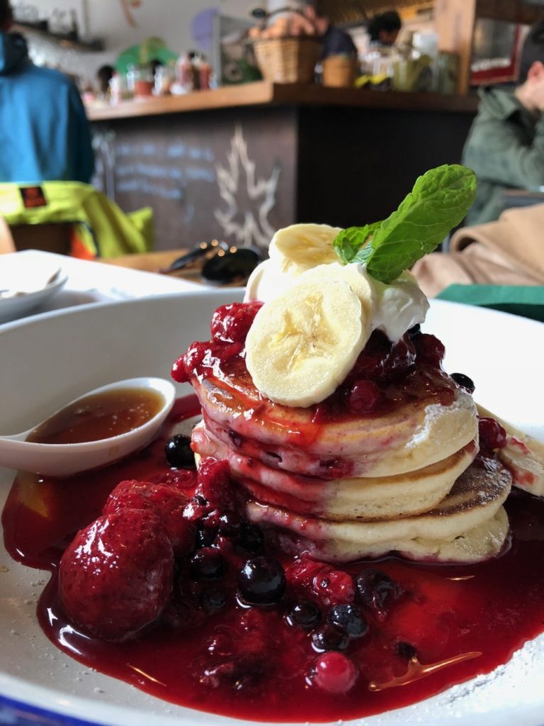 stack of pancakes with fruit coulis