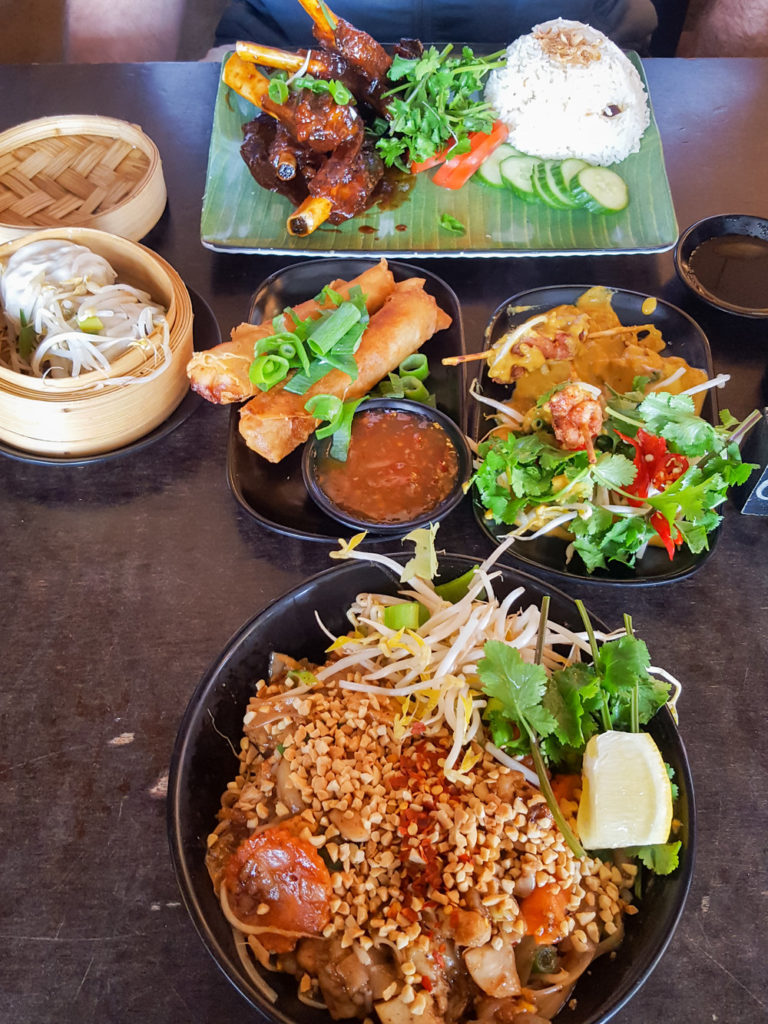 colourful asian food on a wooden table