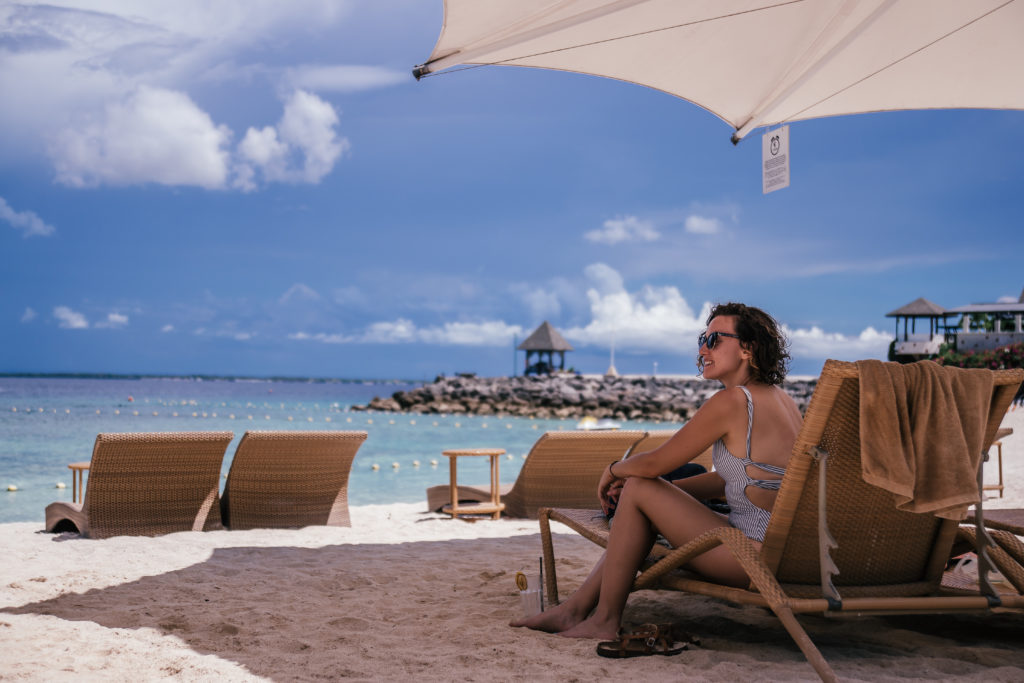 girl on deckchair on beach of resort