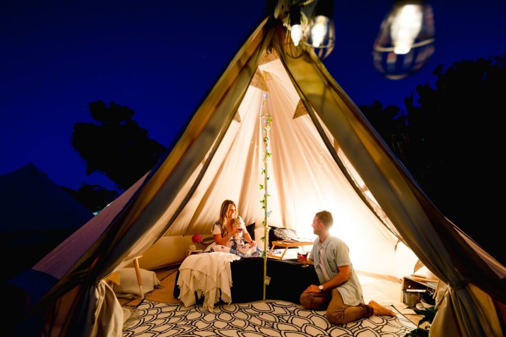 couple inside glamping tent at night