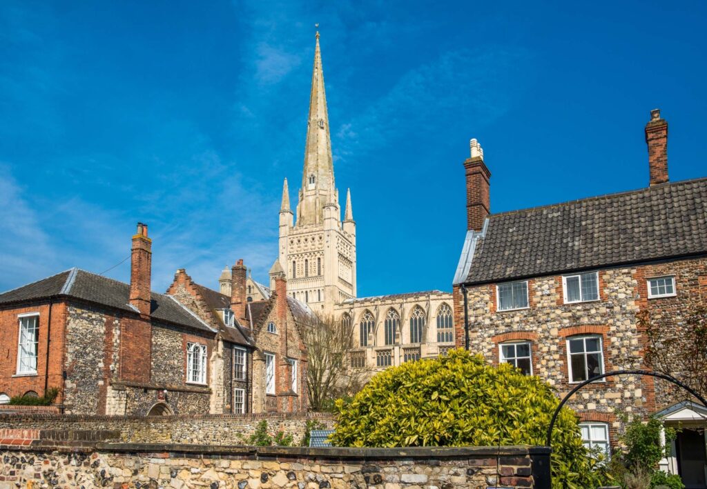 spire of Norwich cathedral behind houses